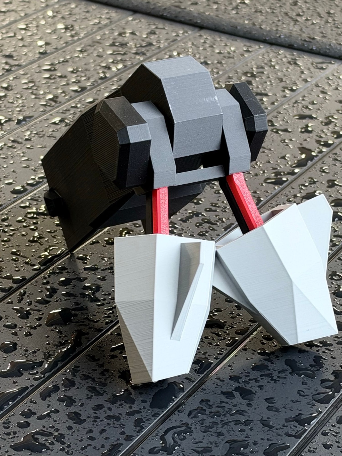 Cyber Nuts: gray faceted nuts on red and black leads, hanging from black and gray hardware