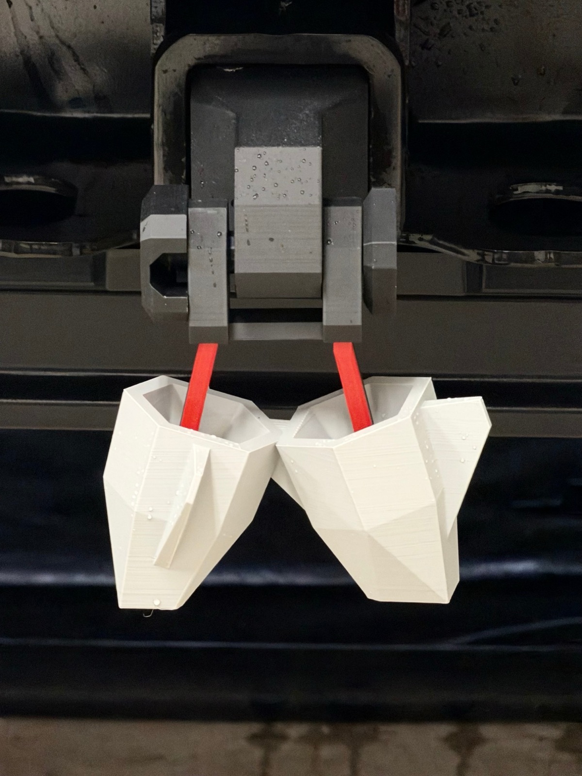 Cyber Nuts hanging straight down from the hitch receiver, red leads visible
